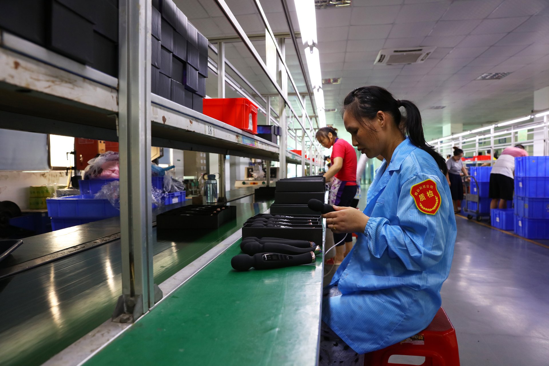 Quality inspector examining finished products on the assembly line